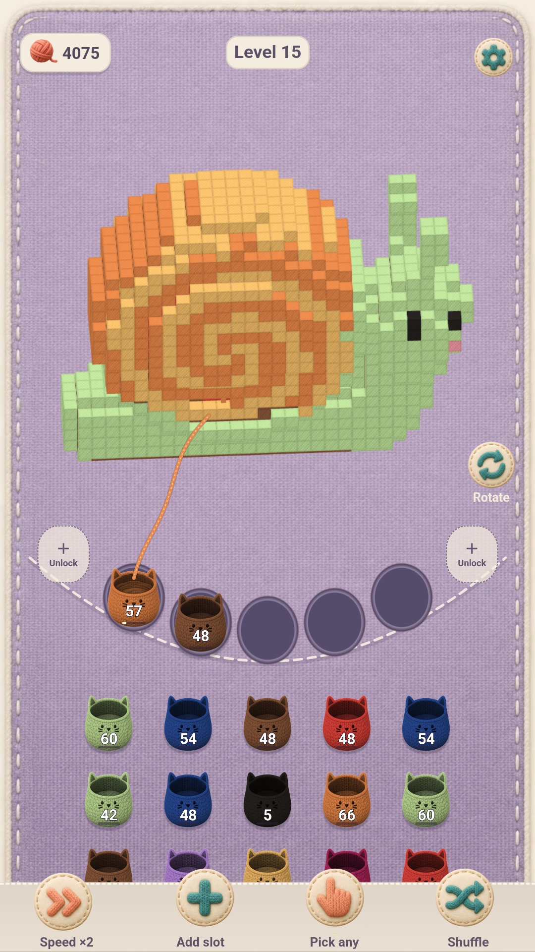 Cozy Yarn Sort gameplay: a yarn snail sculpture with cat baskets on a curved knitted shelf.